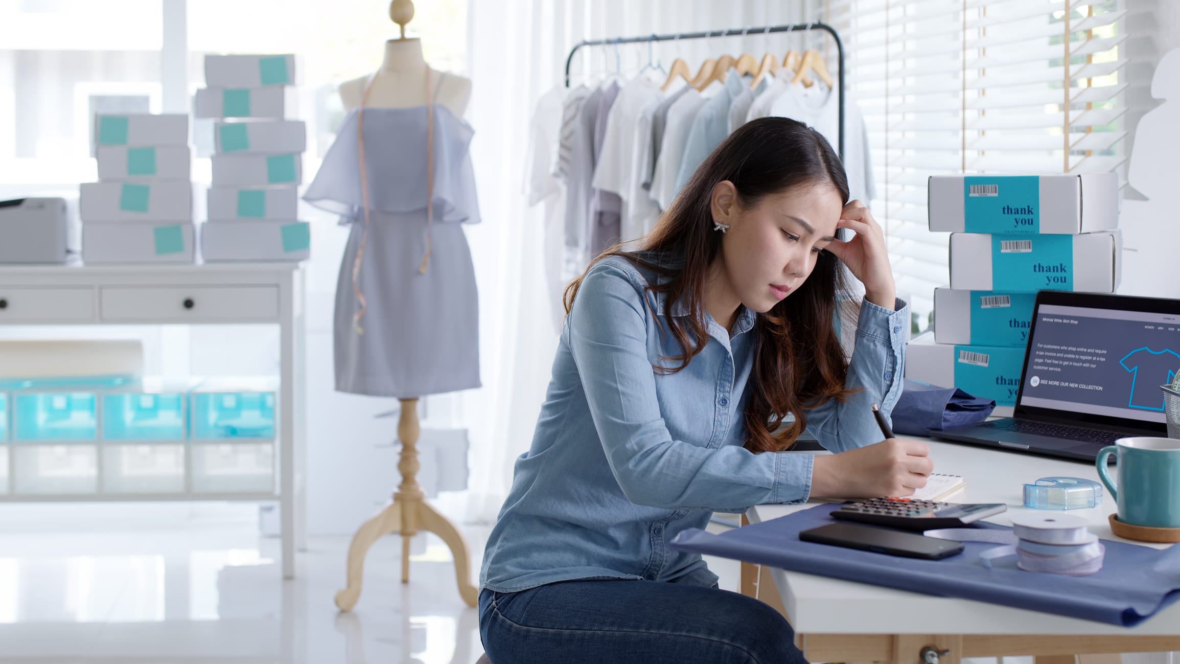 woman stressed on computer during recession trying to increase her sales.