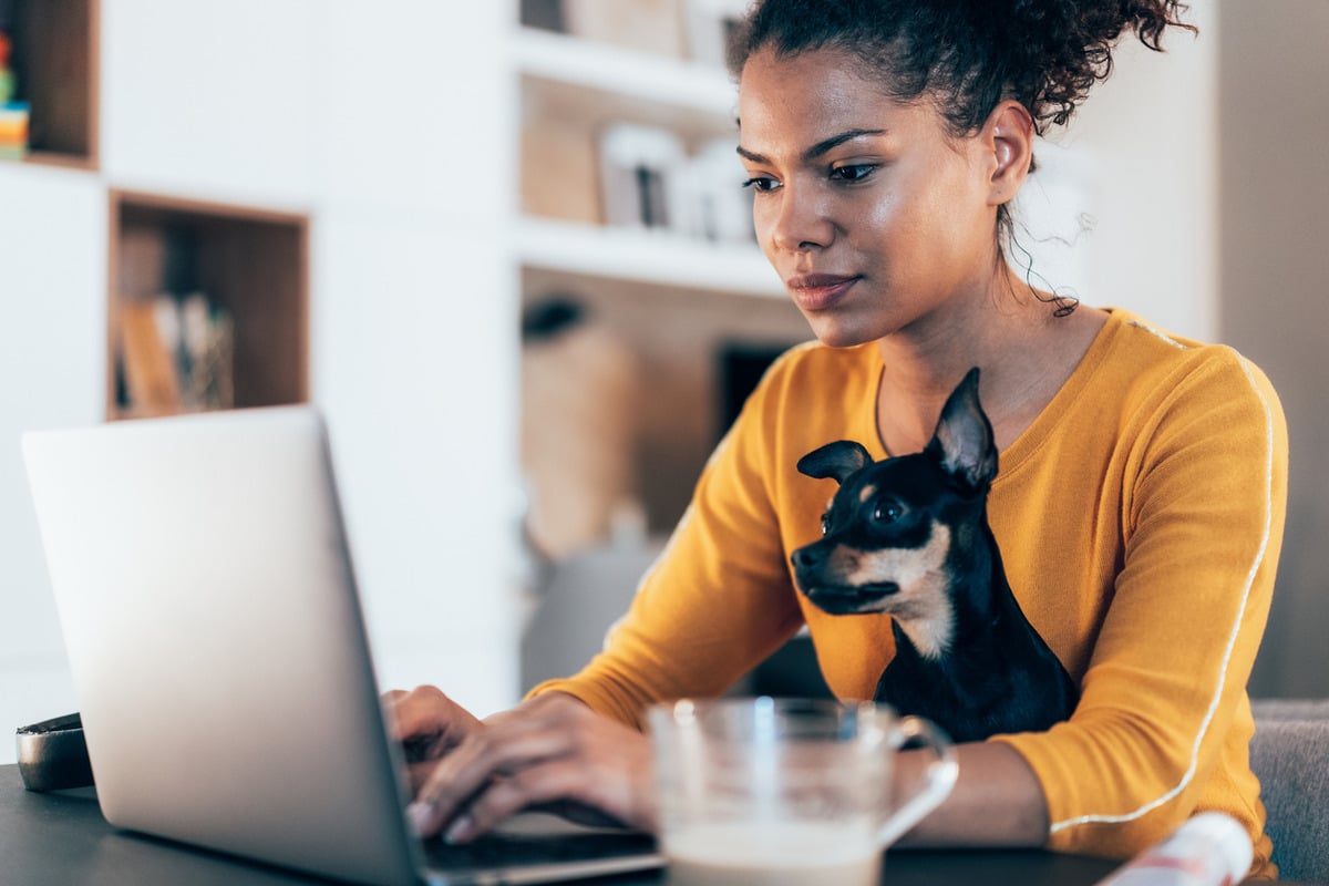 woman with dog on computer